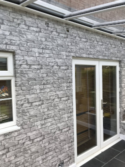Brick effect wallpaper in a conservatory